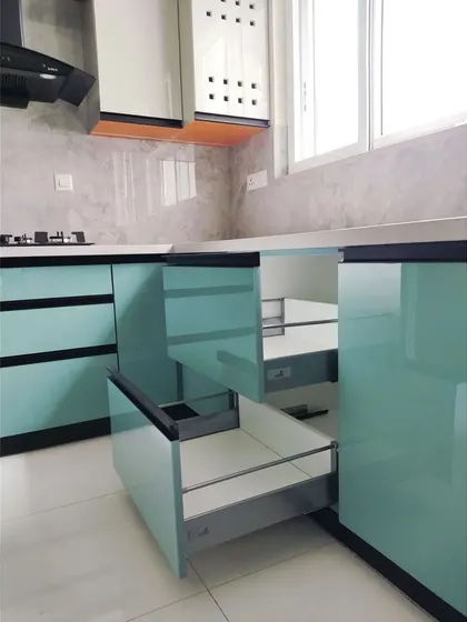 This shot shows the seamless integration of tandem box drawers within the kitchen cabinetry. These drawers offer full extension and a soft-close mechanism, providing smooth operation and easy access to contents.