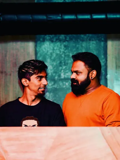 A candid moment with a fellow DJ and friend behind the booth.