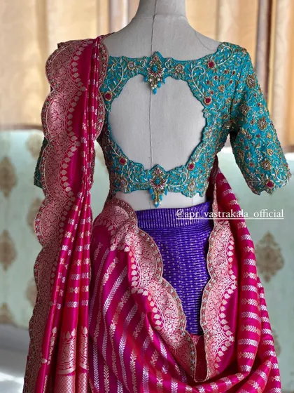 A vibrant half saree set featuring a heavily worked turquoise blouse with a heart-shaped back cutout. This shows how I can create a complete, coordinated look for pre-wedding ceremonies or other grand events.
