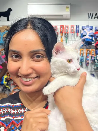 A visitor meets a stunning all-white cat at our adoption camp. It's a chance to see their personalities shine outside of a typical shelter environment.