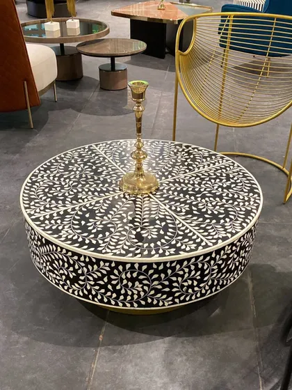 We can't take our eyes off this beautiful bone inlay coffee table. The intricate, handcrafted floral pattern in black and white creates a stunning graphic statement, perfect for adding a touch of artisanal luxury.