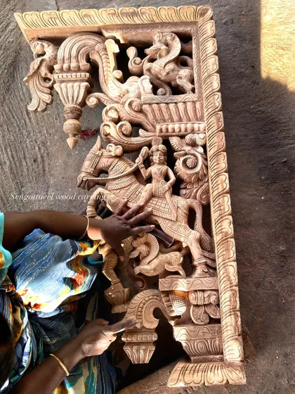 A special 4-foot carving of a horse rider, demonstrating our skill in capturing dynamic scenes. The hands of an artisan are seen giving it a final check.