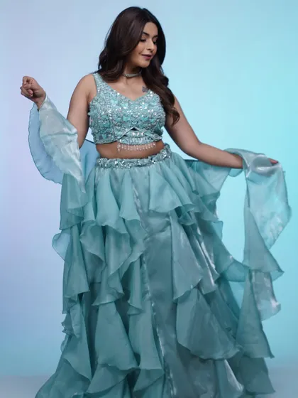 The full look of the ruffled blue lehenga. The voluminous skirt and fitted sequin blouse create a balanced and show-stopping silhouette.