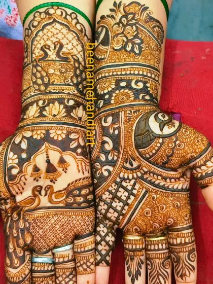 A very rich and detailed bridal design. It is filled with traditional motifs like peacocks, swans, and a 'kalash', creating a very auspicious look.
