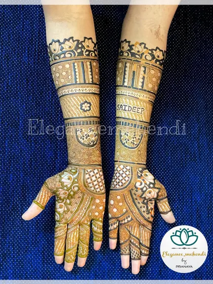 This engagement mehendi includes the name 'Saideep' elegantly written on the forearm, surrounded by traditional patterns.