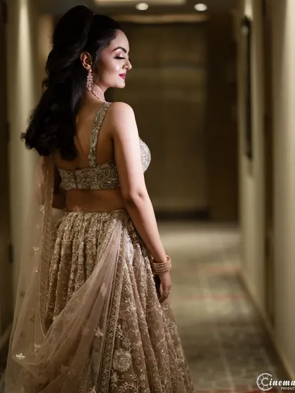 An elegant shot of the bride from behind, showcasing the beautiful back of her dress and her graceful pose.