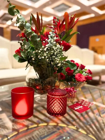Red accents, candlelight, and blooms. Every table tells a love story, and I design centerpieces like this one to add a touch of romance and drama to the setting.