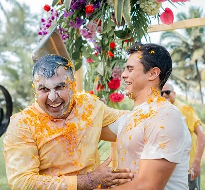 A candid shot of the groom laughing with a friend during the Haldi celebrations.