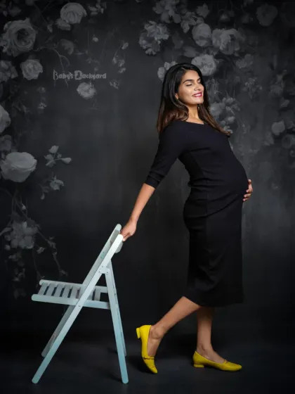 A pop of yellow and a whole lot of style. This happy mom-to-be brings a playful and confident energy to her modern studio maternity portrait.