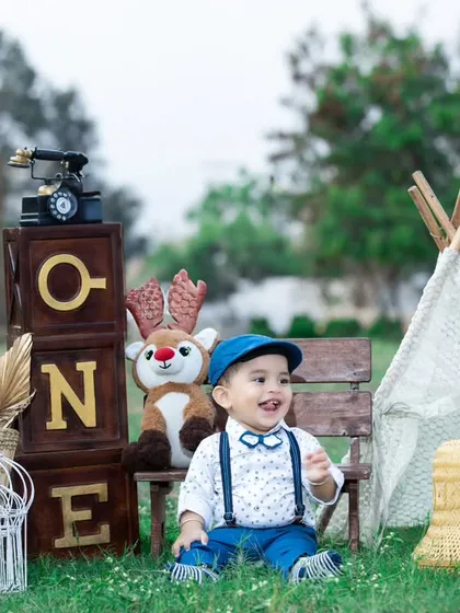 This little boy is all smiles at his outdoor birthday picnic.