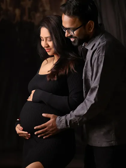An intimate and gentle moment between expecting parents during their maternity photoshoot. Our goal is to create a comfortable space where you can be yourselves.