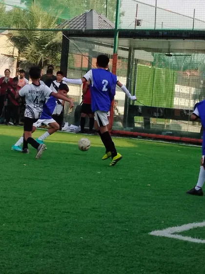 Two players engage in a duel for the ball. These one on one situations are common in games, and our training prepares players to be strong and decisive in these moments.
