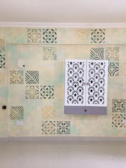 This entryway wall features a unique patchwork of different stencil designs over a soft, cloudy texture. We combined various geometric and traditional tile patterns to create a visually engaging and welcoming space that reflects the home's personality.