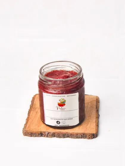 A single jar of handmade strawberry jam. The clean, high-key lighting makes the product look fresh and delicious.