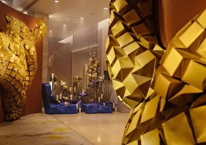 The entrance corridor, where guests walked through a tunnel of golden origami art, creating a sense of discovery.