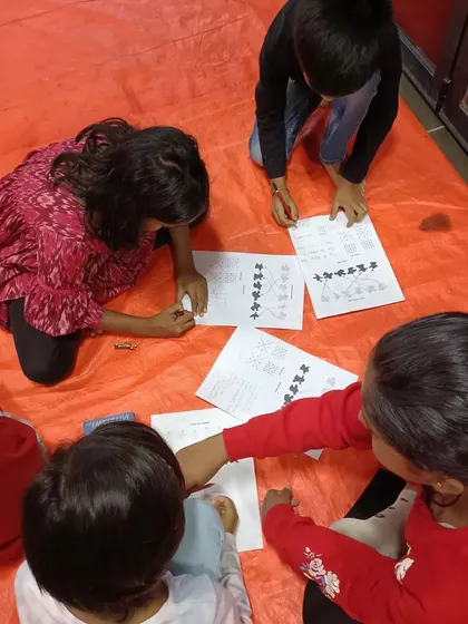 Kids working diligently on their detective worksheets. These activity-based sessions are perfect for making reading and problem-solving feel like an exciting game.