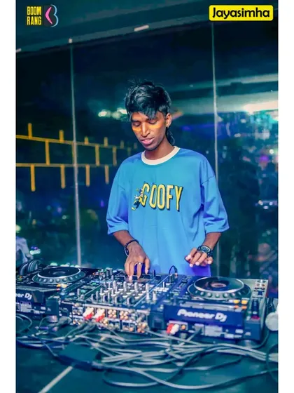 A full-color shot of me mixing, with the blue lighting and 'Goofy' shirt creating a fun, youthful vibe.