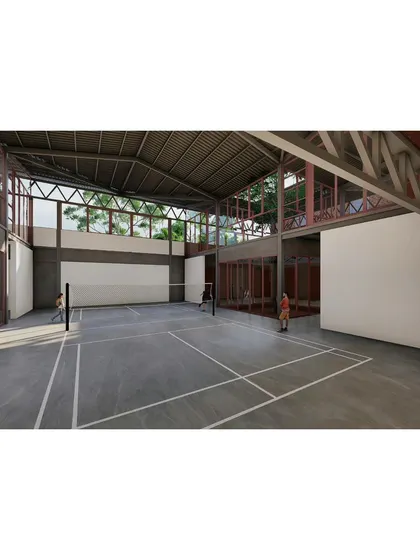 The indoor badminton court, designed with high ceilings and clerestory windows that bring in natural light without glare. The space is visually connected to the rest of the campus, reinforcing the theme of interconnectedness.