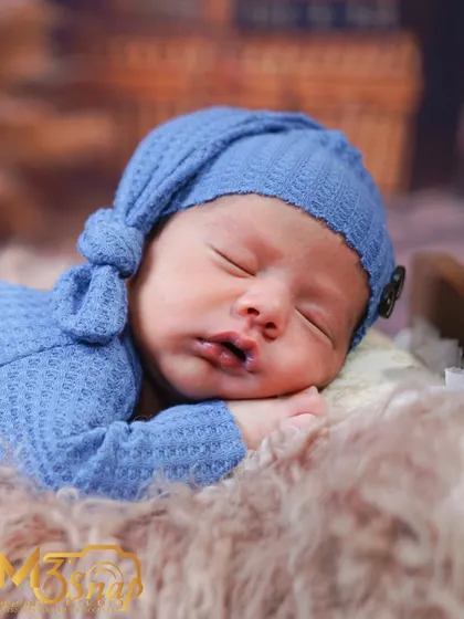 A beautiful close-up of the baby's face, capturing their delicate features and peaceful sleep.