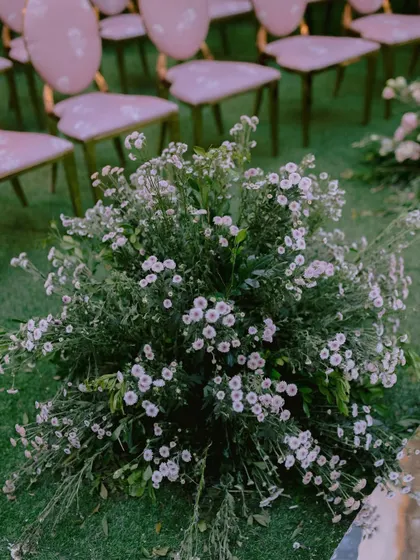 Another look at the floral details from the contemporary mandap. The wild, natural arrangement of flowers growing at the base of the installation grounds the modern design.