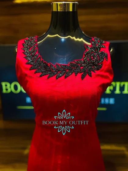 A classic red gown is always a showstopper. For this piece, I added a contrasting black beaded appliqué around the neckline, creating a bold, leaf-like pattern that makes the dress unique.