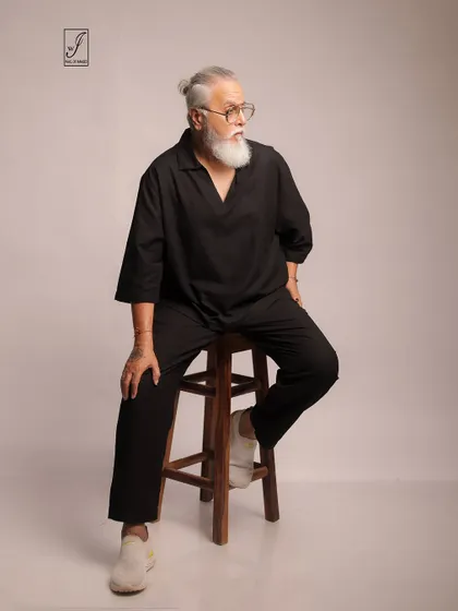 A seated pose that conveys a sense of contemplation and ease, perfect for lifestyle or mature fashion branding.