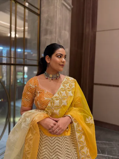 A closer look at the details of this yellow lehenga. The silver choker necklace complements the embroidery on the blouse and dupatta perfectly.