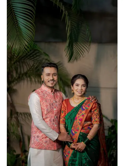 A classic, smiling portrait of the couple against a backdrop of lush green leaves. This is a perfect example of a clean, happy engagement photo.