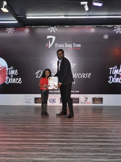A young dancer receiving her award for an outstanding performance.