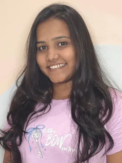 This client is all smiles with her new haircut, featuring gentle waves and healthy-looking ends.
