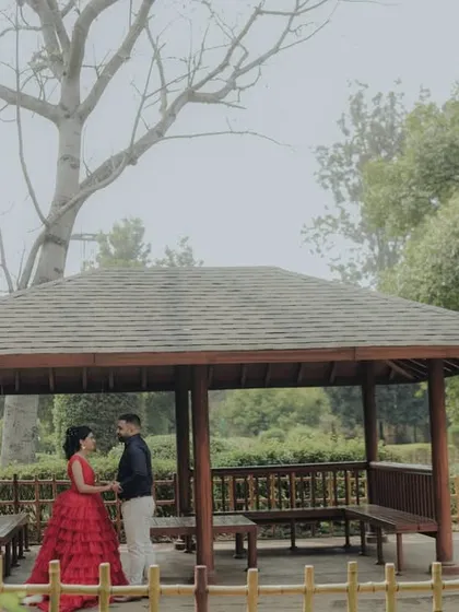 A wide shot capturing the serene atmosphere of a garden gazebo in Pune. This image showcases how I use the environment to frame a couple, creating a sense of privacy and romance in a grander setting.