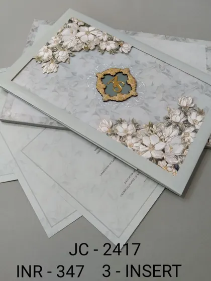A beautiful framed invitation with 3D white flowers on a soft sage green background. This three-insert set is delicate and fresh, ideal for a spring or garden wedding.