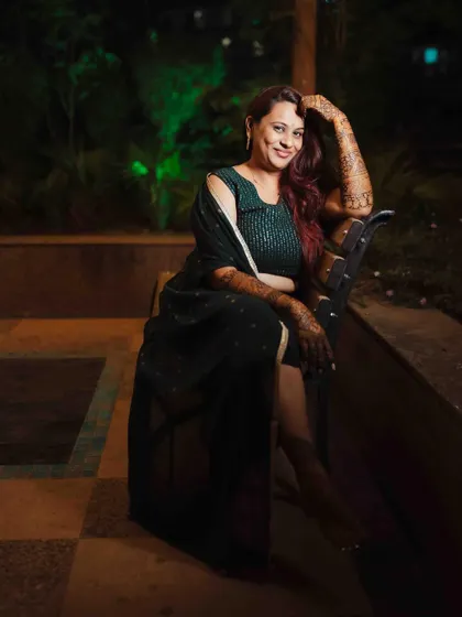 A stylish and confident portrait of the bride, showing off her mehendi and her personality.