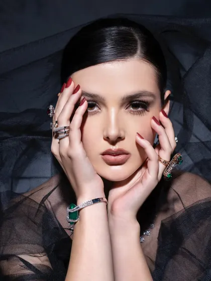 "Be like a diamond, precious and rare." This close-up beauty shot focuses on the intricate details of the rings and bracelet, paired with elegant makeup and a sheer veil to create a sense of mystery and luxury.