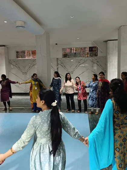 Connection is key. This circle of teachers holding hands is a physical representation of the community and trust we build in my workshops, which is essential for creating a positive learning environment.