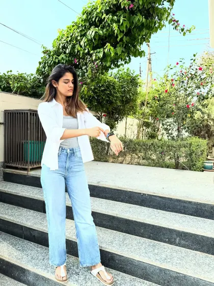 A candid moment checking the time. Even in a basic outfit, good posture and carrying yourself with confidence is the best accessory.