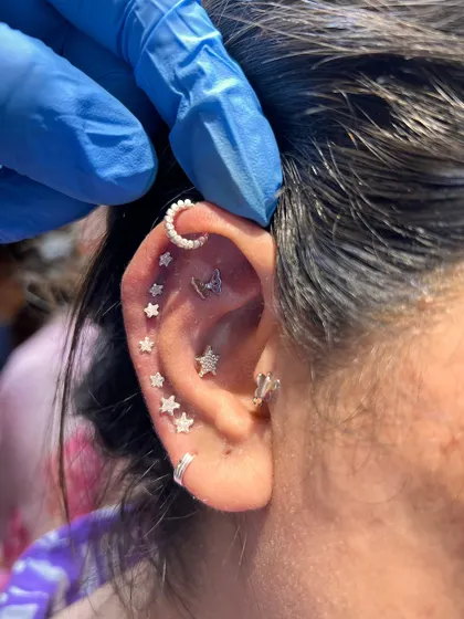 This fully curated ear is a galaxy of its own. We combined multiple star studs, a crescent moon hoop, and a butterfly stud to create a truly magical and personalized look.