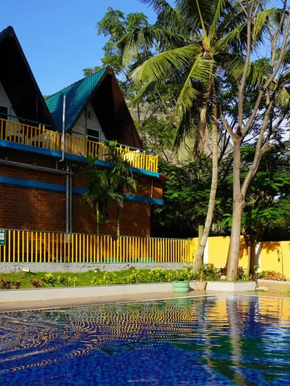 A view of the A-frame cabins from our swimming pool at Nandi Hills. You can relax in the water while enjoying the unique architecture of the resort.