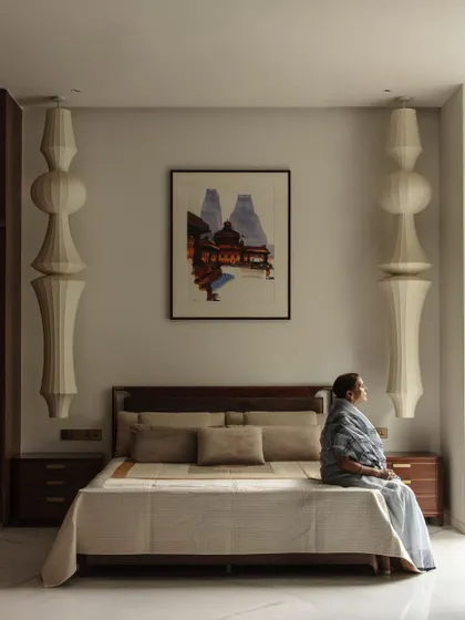 We design spaces that reflect the user. This serene bedroom, with its custom pendant lights inspired by temple architecture, is a quiet sanctuary designed for the family's matriarch.