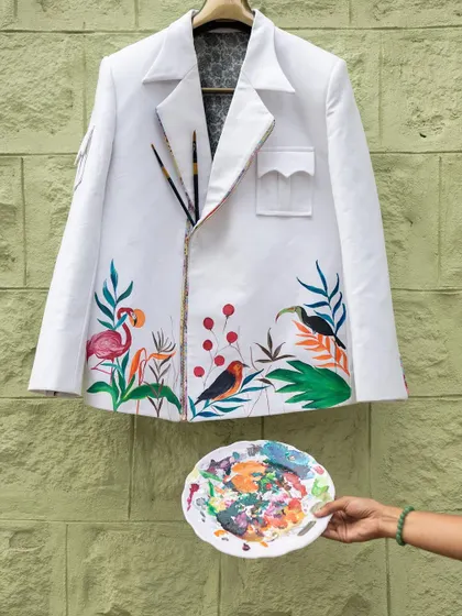 The elements of the forest come together on this jacket. I painted a serene scene with flamingos, toucans, and other birds nestled among tropical leaves and berries.