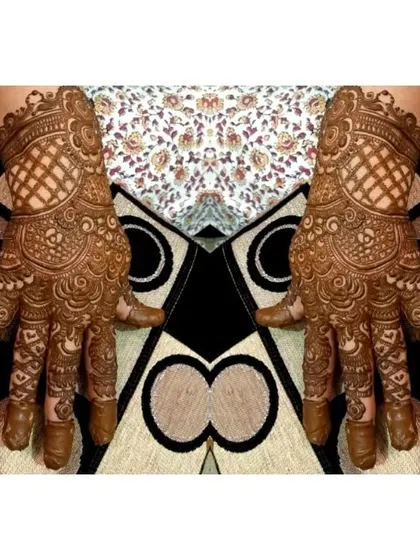 A beautiful guest mehndi design featuring a checkerboard pattern on the wrist and intricate work on the palm.