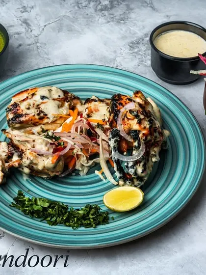 Our Arabi Tandoori features a whole chicken marinated in a creamy, white sauce with mild Arabic spices. It's cooked in the tandoor, resulting in juicy, tender meat with a subtle, smoky flavor.