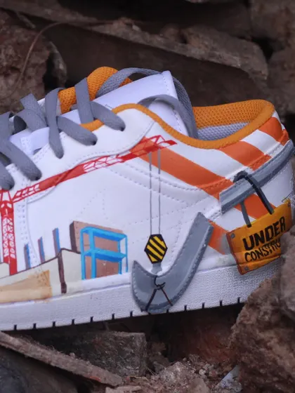 A detail shot of the construction-themed custom sneaker, where the Nike swoosh is transformed into a crane hook. It's these little details that make a custom design special.