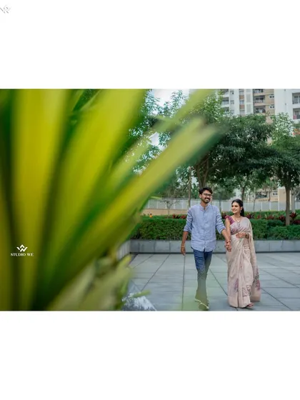 A couple walking hand-in-hand in a modern residential complex. This shows that beautiful pre-wedding photos can be taken anywhere, even in everyday urban environments.