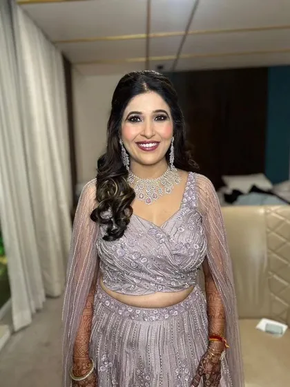 The groom's mom, looking radiant and ready for the Sangeet. I created a sophisticated glam look that enhances her features and complements her beautiful pastel outfit.