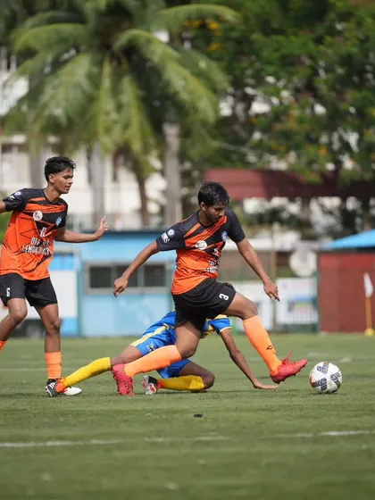 Battling through a tough tackle to maintain possession, highlighting the resilience and fight in our team.