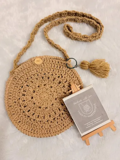 This simple and stylish round boho sling bag is one of my favorite designs. It's crocheted with sturdy yarn and features a minimalist design with a wooden button closure and a tassel for a bit of fun.