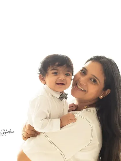 This is us. A simple, beautiful portrait of a mother and her son on his first birthday. The clean, high-key background keeps the focus entirely on their connection.