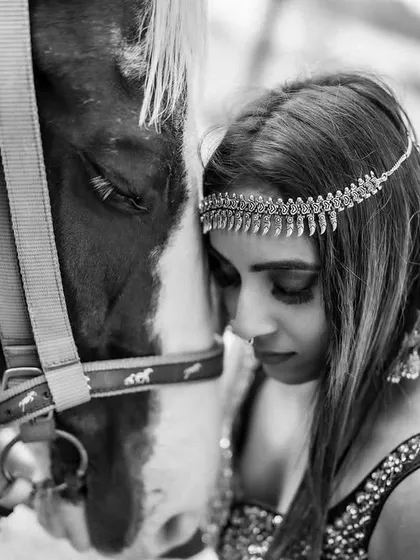 A powerful and intimate black and white portrait with a horse. This shot focuses on the connection and trust between the subject and the animal, creating a deeply emotional image.