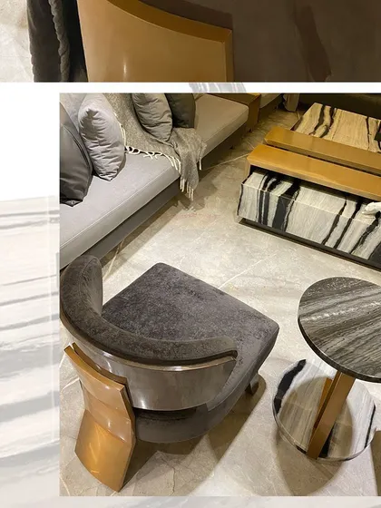 Every piece of furniture is an opportunity for a design statement. This custom armchair features a curved wooden frame with a metallic finish, paired with a matching side table, creating a cohesive and elegant seating nook.